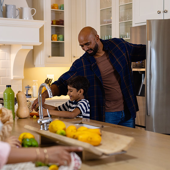 smiling-father-and-son-retrieving-ingredients-from-the-refrigerator We-need-to-control-the-rising-img